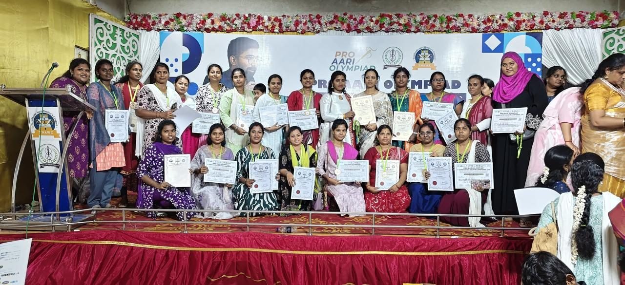 Vinu Fashion Academy students celebrating their Pro Aari Olympiad certifications on stage