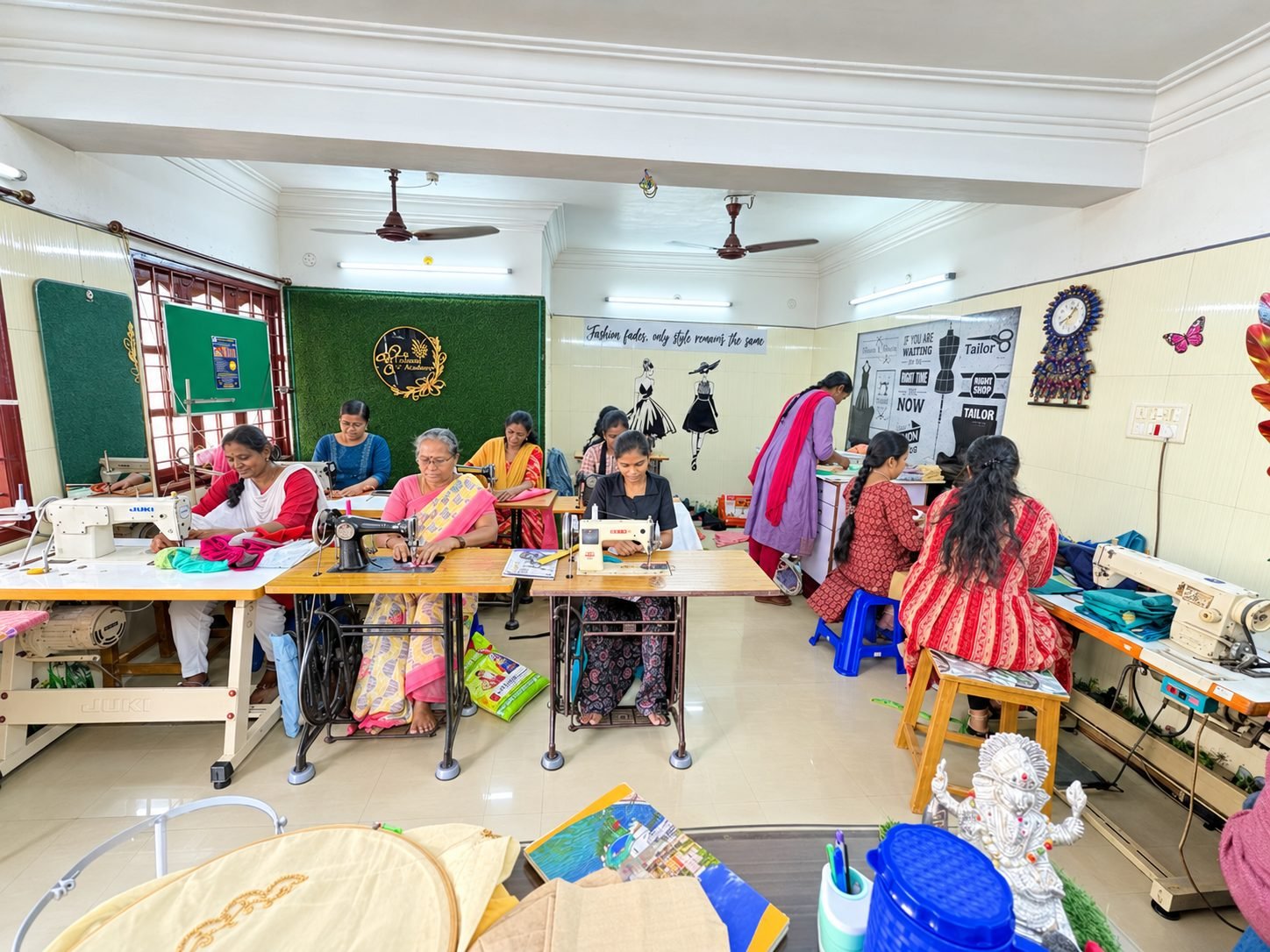 Students training at sewing machines and embroidery frames inside the Vinu Fashion Academy classroom